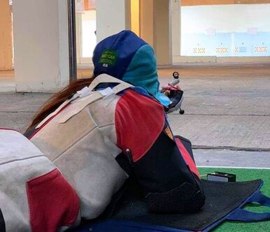 A smallbore shooter aiming down the 25-yard range